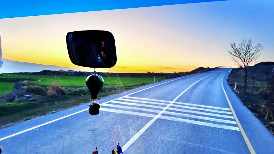 Road across the Anatolian plateau at sunset, seen from the coach windscreen