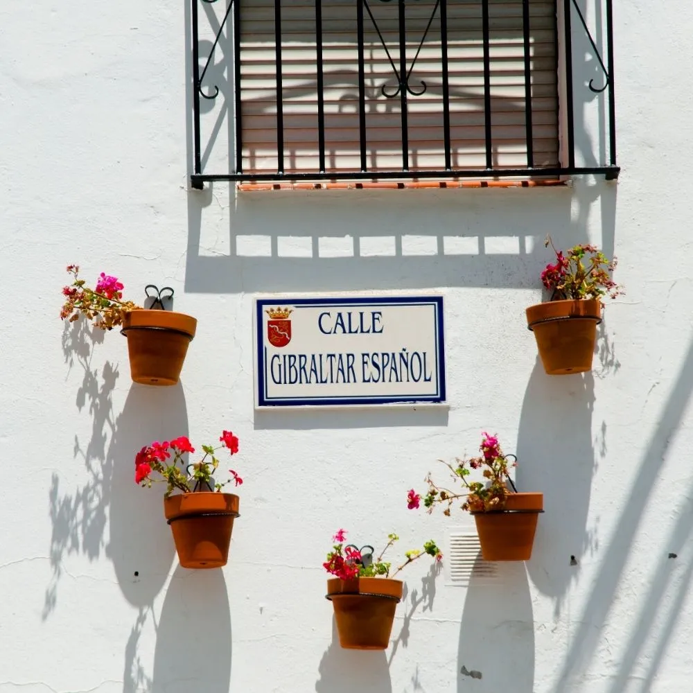 Flower-lined white street in an Andalusian village, southern Spain