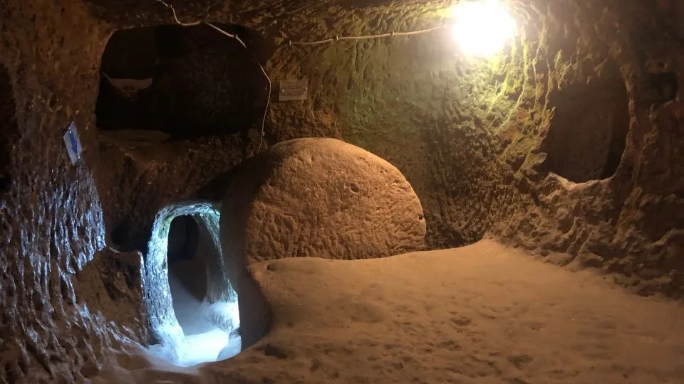 Sliding stone door of the Özkonak Underground City – Colorido Tours