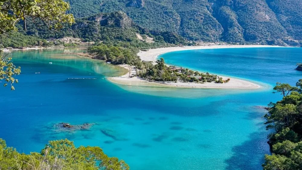 The Ölüdeniz lagoon seen from the viewpoint, with its sand spit, turquoise water and the mountains behind