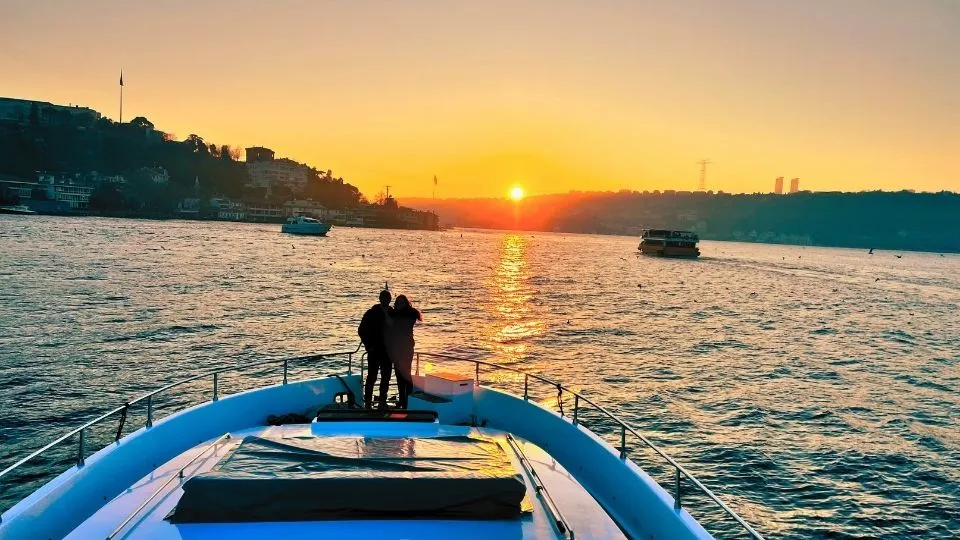 Couple on the bow of a boat at sunset on the Bosphorus
