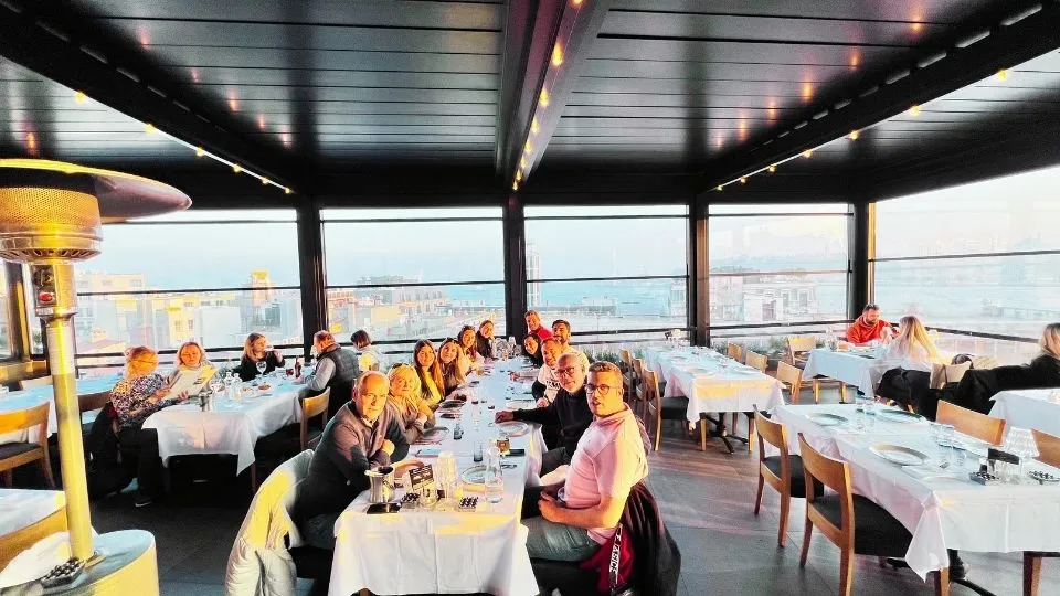 Group dinner on a terrace overlooking the Bosphorus at dusk